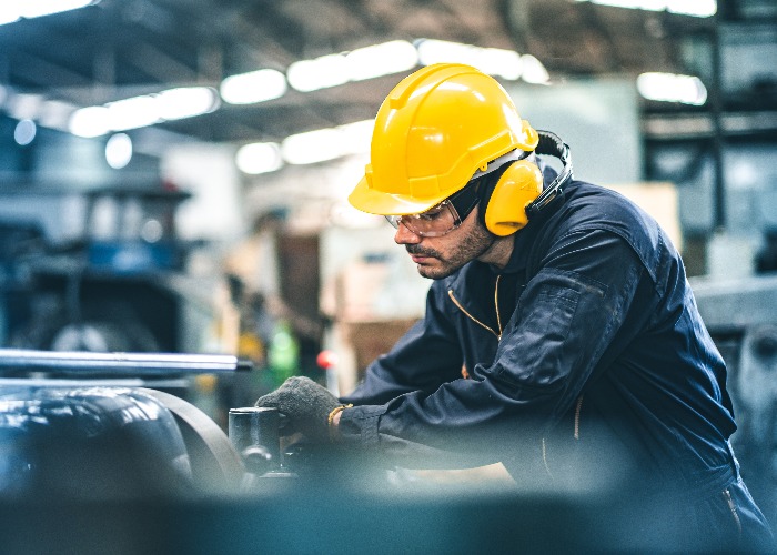 Industrial Engineers in Hard Hats.Work at the Heavy Industry Manufacturing Factory.industrial worker indoors in factory. man working in an industrial factory.Safety first concept.